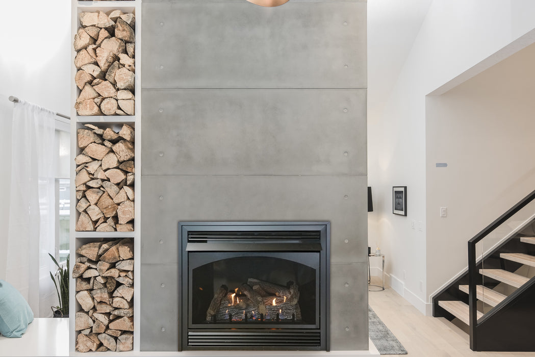 Empire Vail 32 vent-free fireplace with Sassafras logs and black porcelain liner in a concrete wall