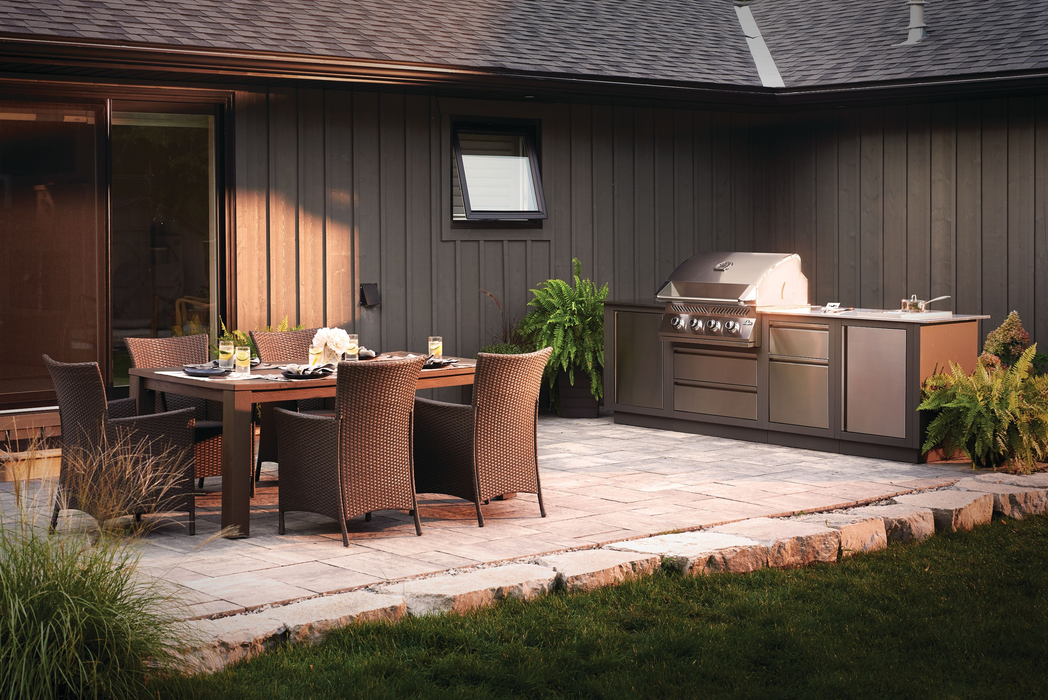 Napoleon Grills 500 Series 32 Built-in Gas Grill - installed in an outdoor kitchen on a patio at dusk