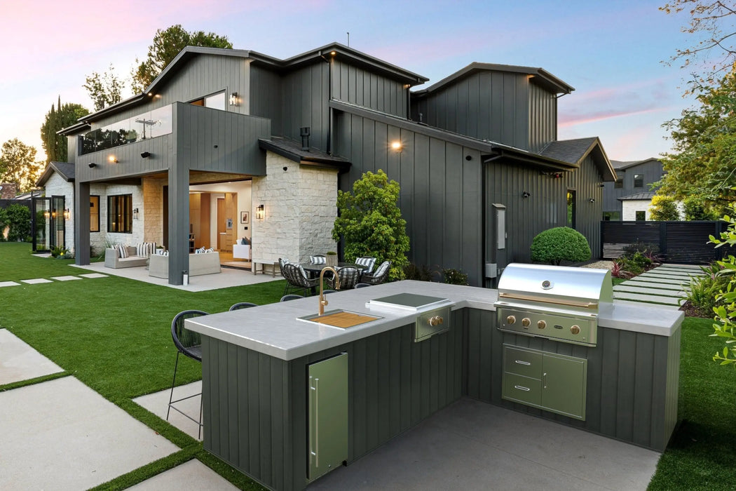 Wildfire Ranch Pro 36" gas grill with brushed bronze Designer Finish hardware built into an L-shaped outdoor kitchen island