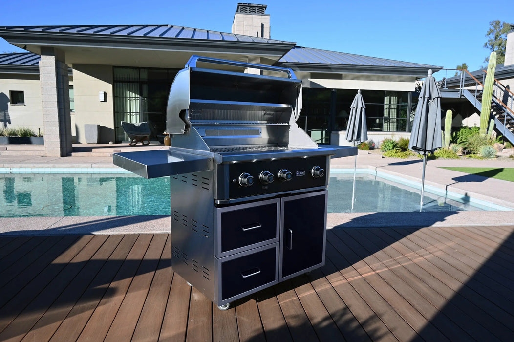 Wildfire Ranch Pro 36" gas grill in black stainless steel on its cart beside a pool, hood open
