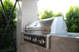 Wildfire Ranch Pro 42" gas grill in black stainless steel with brushed bronze Designer Finish hardware built into a stone island, hood closed