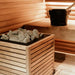 HUUM CORE sauna heater with thermo-aspen panels set beside a sauna bench