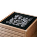 Close-up of the HUUM CORE sauna heater with thermo-aspen panels and black top grate filled with stones