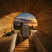 HUUM CORE electric sauna heater with wood panels installed in a barrel sauna