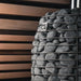 Close-up of sauna stones stacked in the HUUM HIVE Flow stone cage
