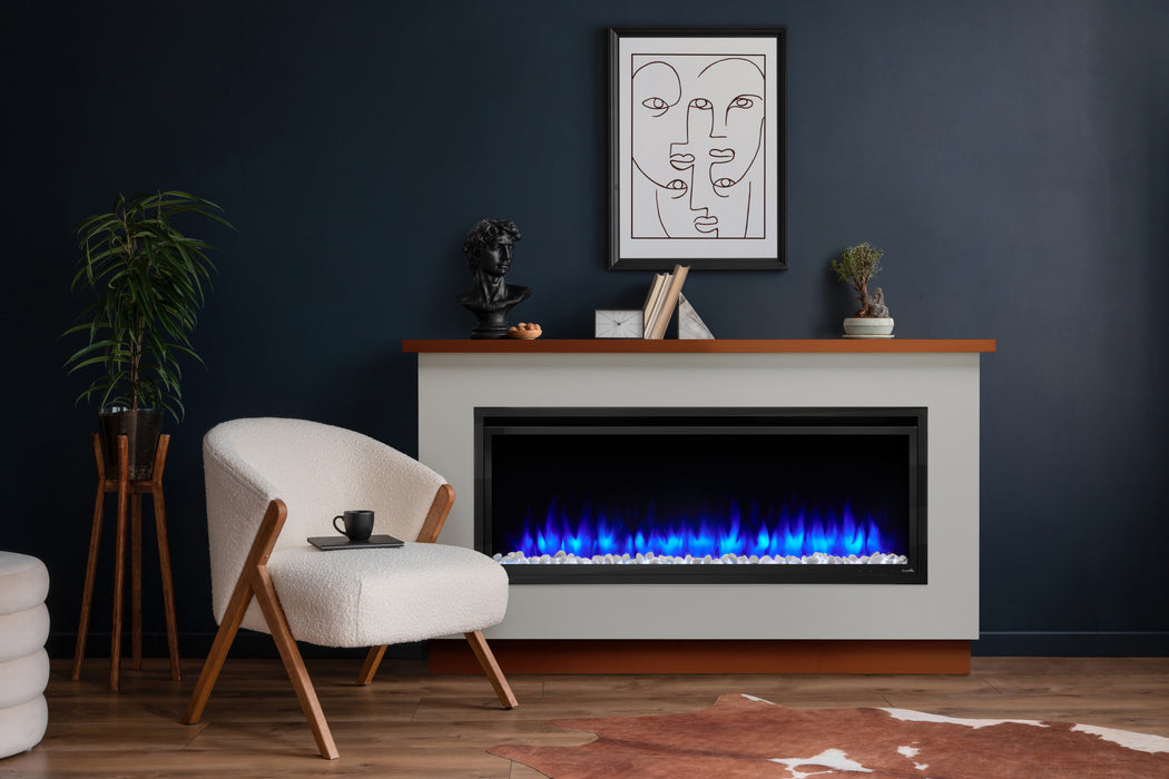SimpliFire Ready-to-Finish Boyd build-out kit, shown painted, with Allusion Platinum 50" fireplace beside an armchair on a navy wall